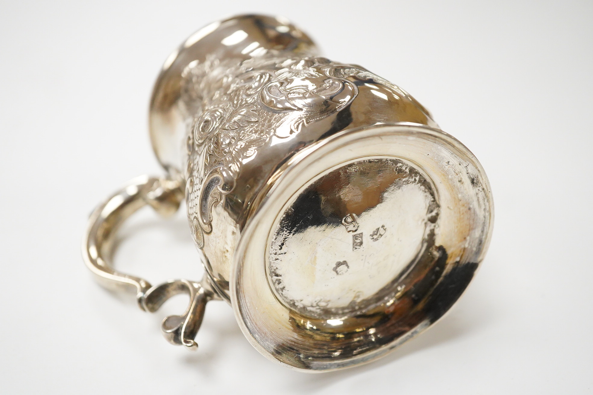 A George II silver baluster mug, by John Bayley, London, 1751, with later embossed decoration, height 95mm, 6.4oz.